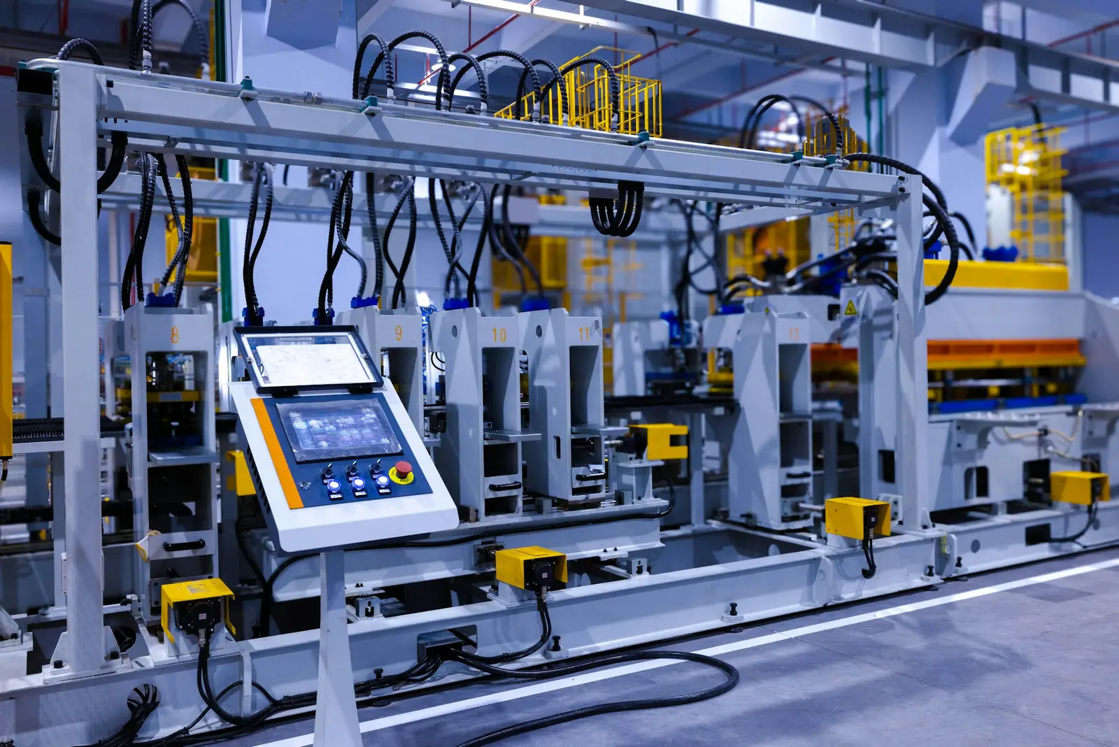 Operator touch panel with push buttons and emergency stop on an automated production line